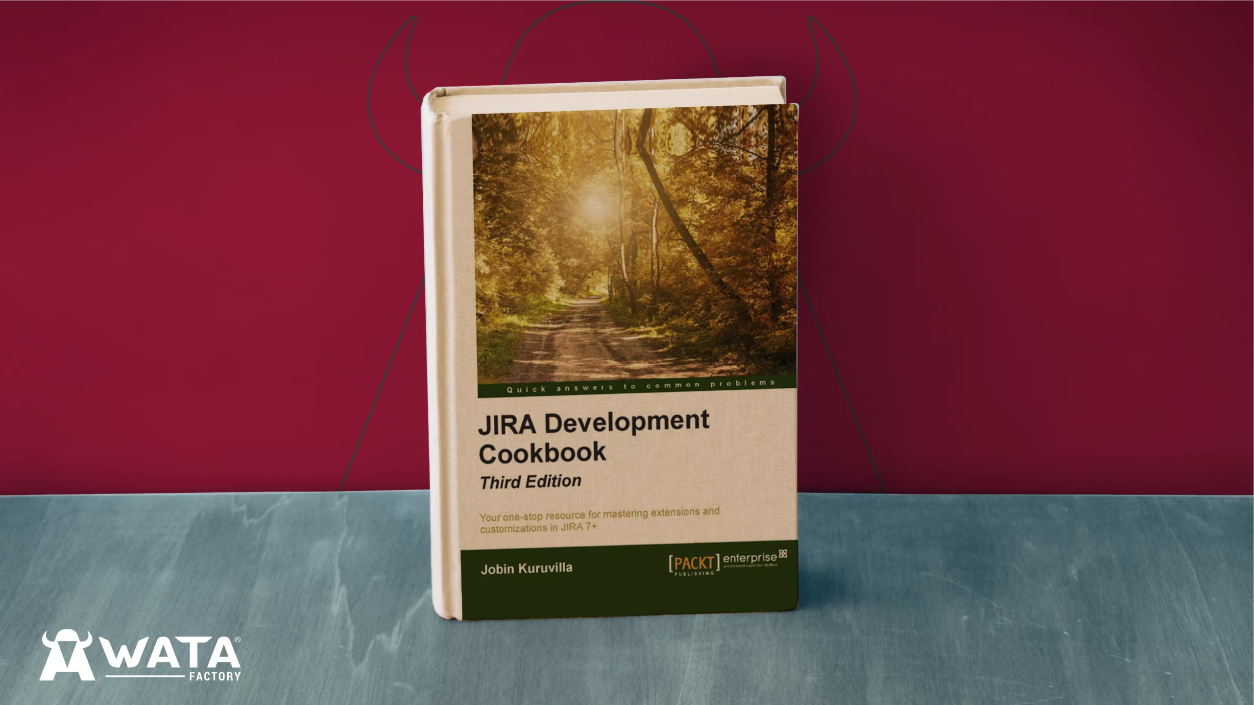 Development Cookbook book by Jobin Kuruvilla standing upright on a background featuring WATA Factory’s corporate colours, with the company logo visible behind.