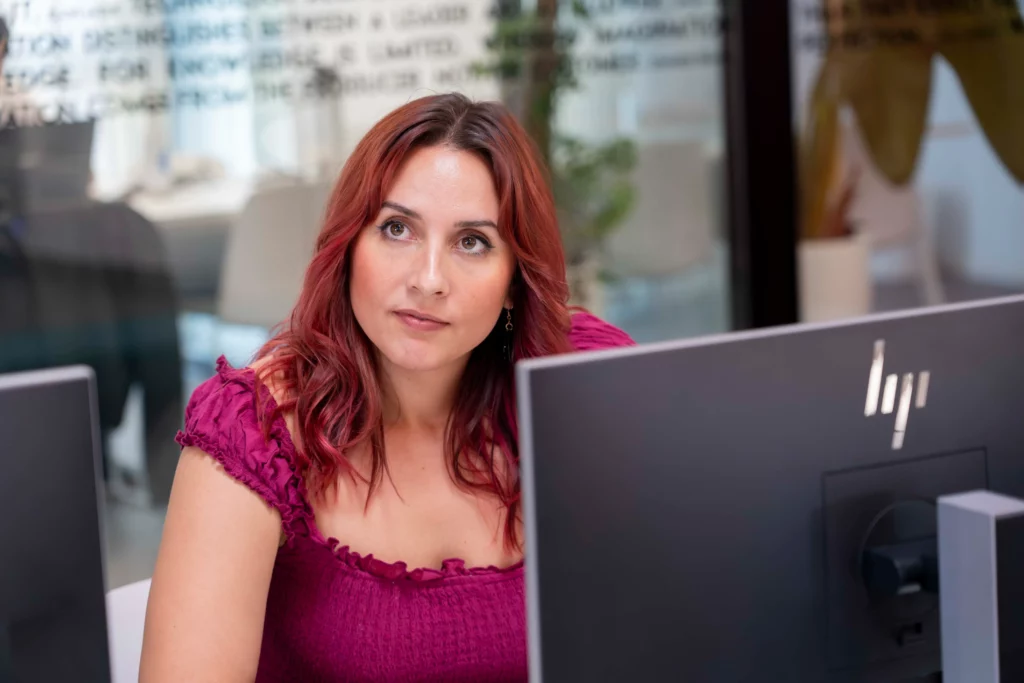 WATA Factory employee focused on her laptop following the DevOps and Kubernetes workshop.