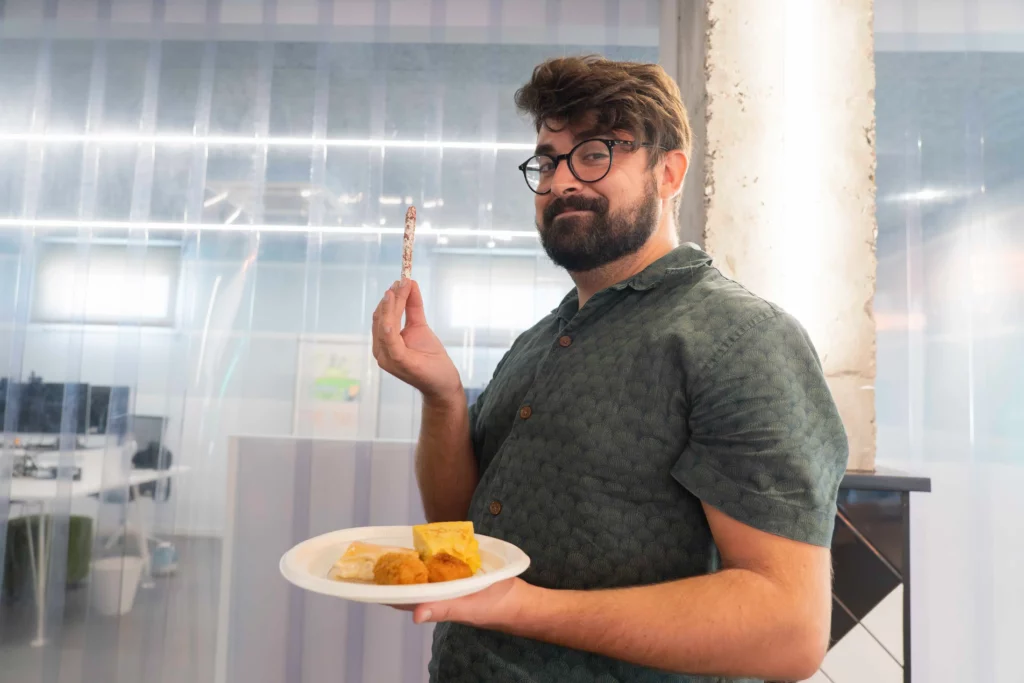 WATA Factory employee proudly showing his plate with selected food from the lunch buffet.