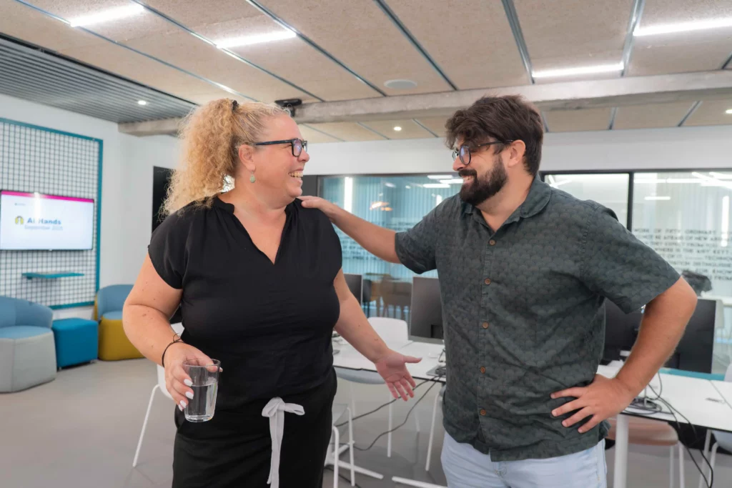 Two WATA Factory colleagues happily saying goodbye in the office after the All Hands.