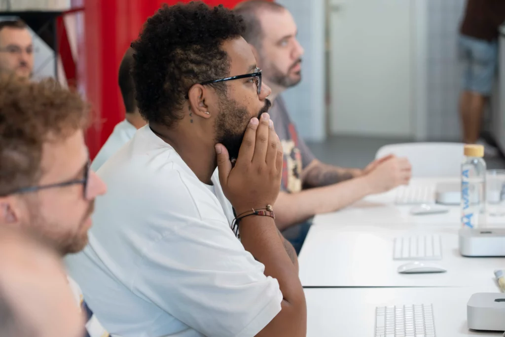 WATA Factory employees following the hands-on practice on laptops guided by Pedro G. on Kubernetes.