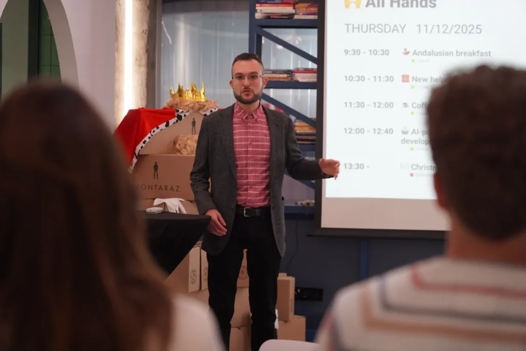 Eliezer L., Director at WATA Factory, explaining the agenda and schedule of the Christmas All Hands.