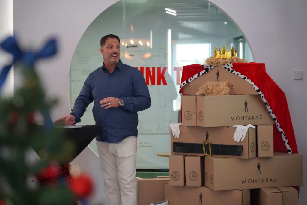 Carmelo B. introducing his presentation about the new support tool with Christmas decorations in the background.