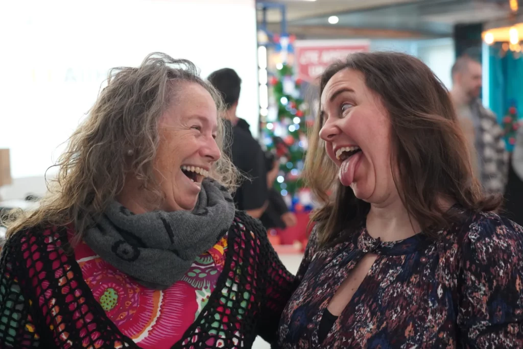 Two colleagues posing playfully together during a relaxed moment at the All Hands.