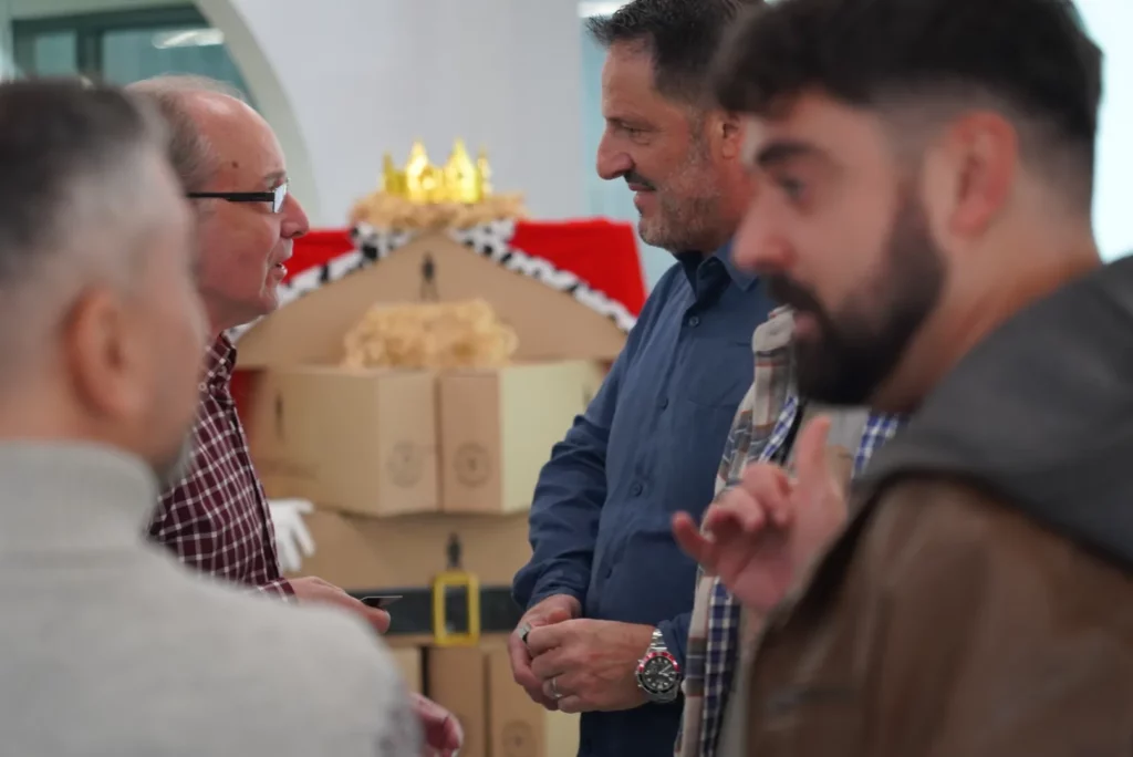 Colleagues chatting and sharing impressions during the coffee break at the Christmas All Hands.