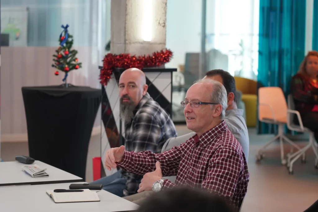 A colleague enthusiastically sharing his opinion during the technical discussion on Figma Make.