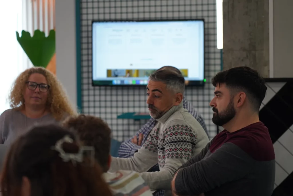 A colleague expressing technical doubts about Figma Make through body language during the talk.