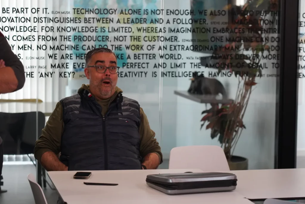 Germán T., CEO of WATA Factory, reacting with surprise when hearing his name in the Christmas carol.