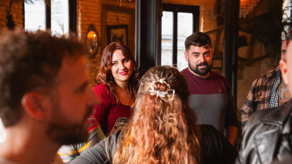 Colleagues chatting animatedly in a retro environment during the Christmas celebration.