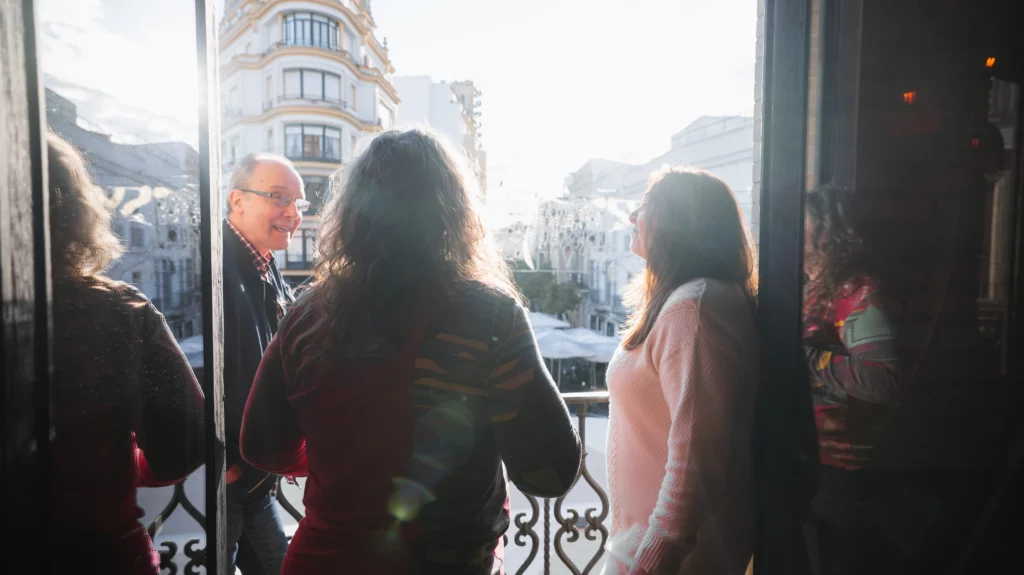 Colleagues chatting on a terrace overlooking the city during the Christmas All Hands.