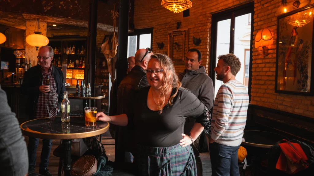 A colleague smiling and posing in a medieval-style festive environment.