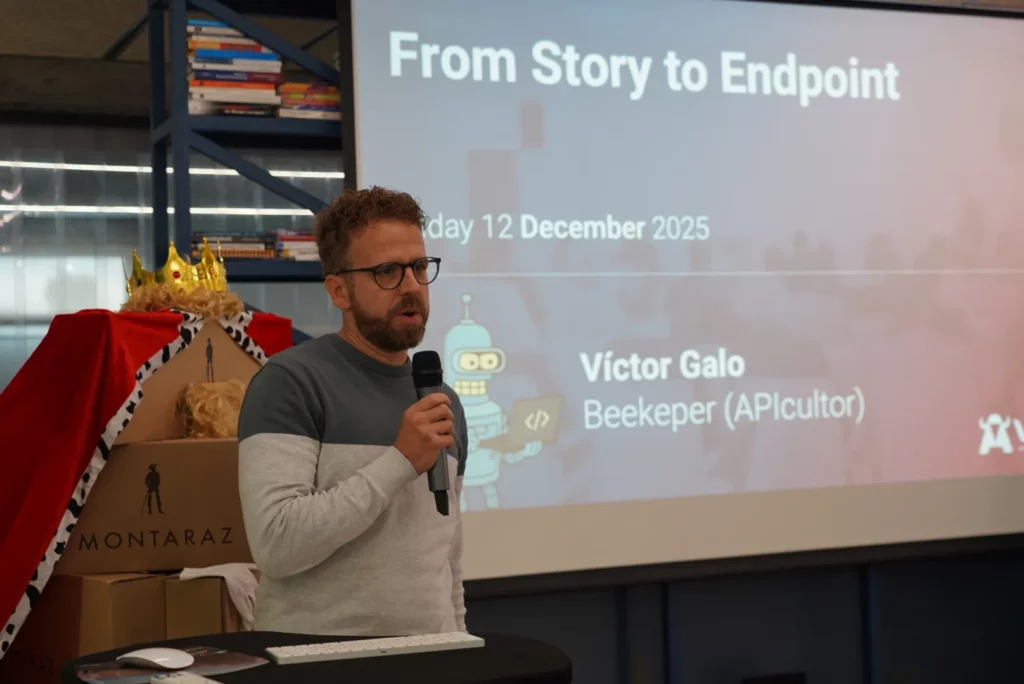 Víctor G. presenting his API talk with a visual joke related to technological beekeeping.