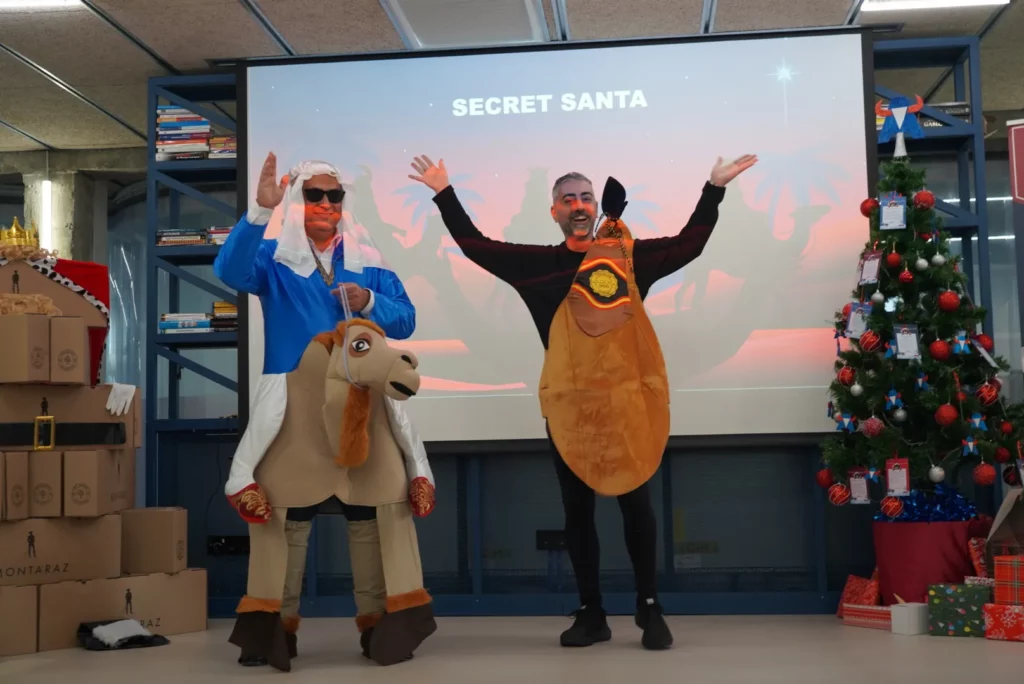 Pedro G. dressed as a Bedouin and Juan Miguel G. dressed as a ham greeting from the stage.