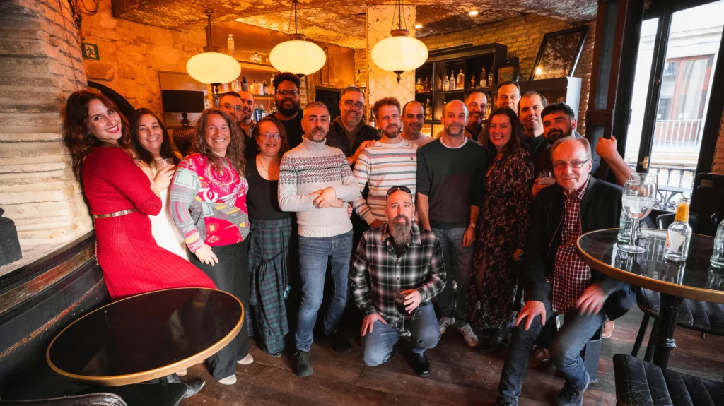 Entire WATA Factory team posing at El Gallo Azul with smiles and a retro Christmas atmosphere.