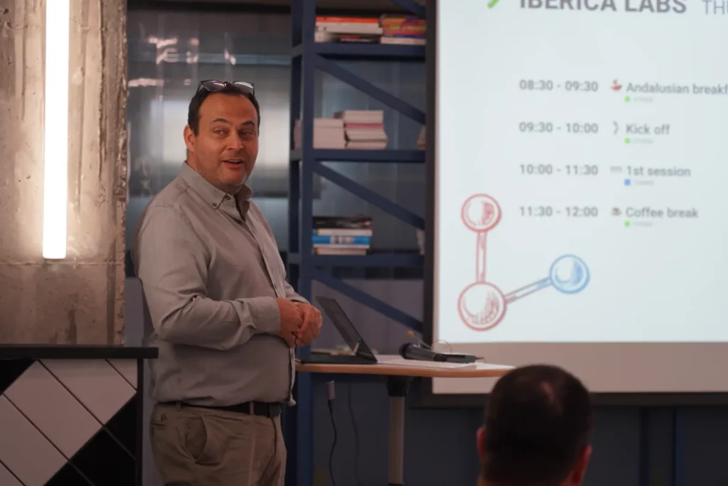 Pedro G. explains the Iberica Labs agenda to the WATA Factory team before the technical sessions begin.