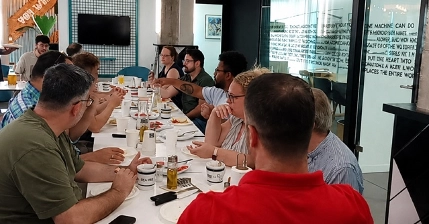 Ibérica Labs participants sharing breakfast and conversations at WATA Factory, encouraging collaboration and knowledge exchange between teams.