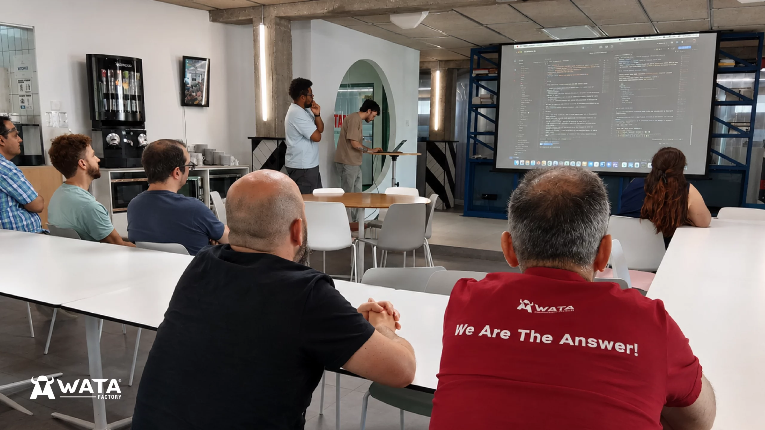 Attendees at Ibérica Labs taking part in a technical session on artificial intelligence and process transformation during an innovation event at WATA Factory.